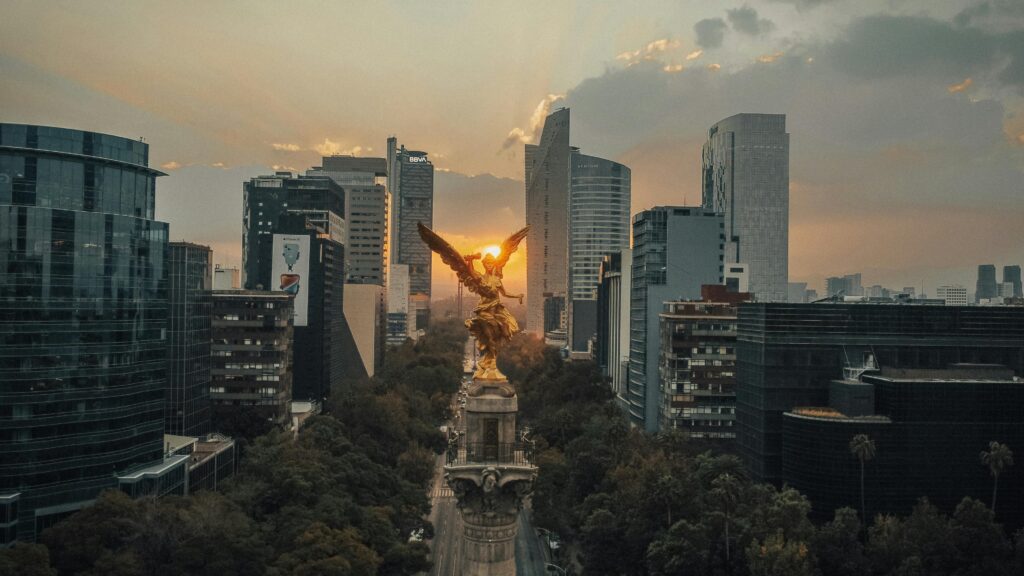 A stunning aerial view of the Angel of Independence monument at sunset in Mexico City.